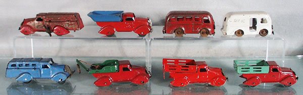 8 MARX TRUCKS: painted pressed steel, Gas Truck, red, paint worn, Dump Truck, red & blue, Bus, red, paint worn, Milk Truck, white, Bus, blue, Wrecker, red & green, Stake Truck, red & green, windup working, Stake Tru