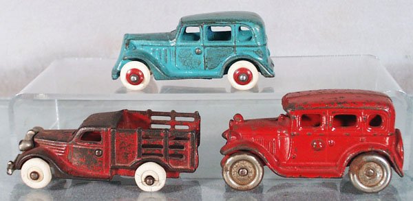 ARCADE & AC WILLIAMS VEHICLES: painted cast iron, Arcade Chevrolet Sedan, 4" long, restored & aged, Arcade Stake Truck, nickel grille, bumper broken, 4 3/4" long, AC Williams Sedan, 4 1/4" long, C3-6.
