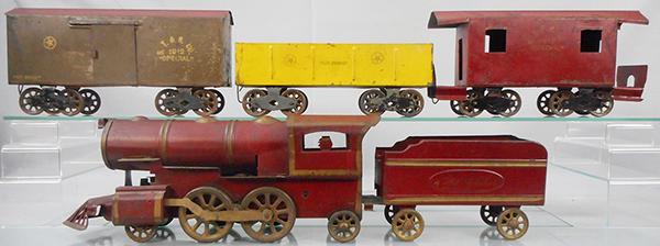 SCHIEBLE 1912 SPECIAL TRAIN SET: painted pressed steel, 2-4-2 Hillclimber loco, Hillclimber tender, ST&N Co 1912 Special box car, missing 1 door, Fast Freight gondola, caboose, abbreviation is Schieble Toy & Novelty Co, train is 66 i