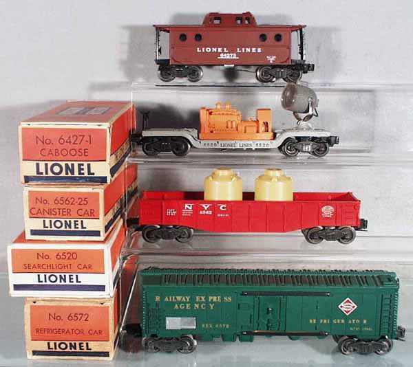 4 LIONEL FREIGHT CARS: O ga, 6427-1 caboose, 6520 searchlight, 6562-25 canister car, 6572 refrigerator car, orig boxes minor wear, C5-7.