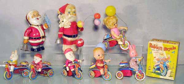 016: 8 JAPANESE TOYS: litho tin, 2 Santa Claus bell ringers, 6 character tricycles, all are windup working, 1 orig box only, C5-8.