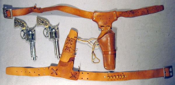 095: 2 MATTEL SHOOTING SHELL FANNER TOY CAP PISTOLS: die cast w/plastic grips, leather holsters, 1 gun not working, w/toy bullets, C5-6.