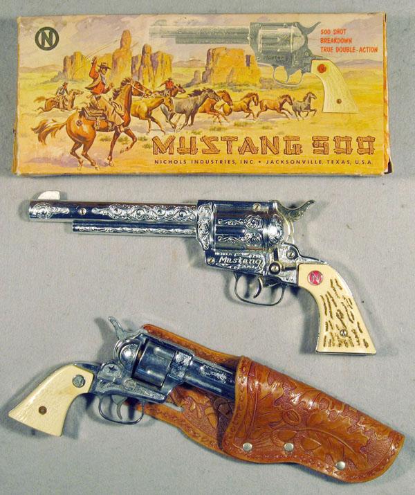 098: 2 NICHOLS TOY CAP GUNS: die cast, #505 Mustang 500, 12" long, unused, orig box worn, Stallion 38, w/partial holster, 9" long, C6-9.