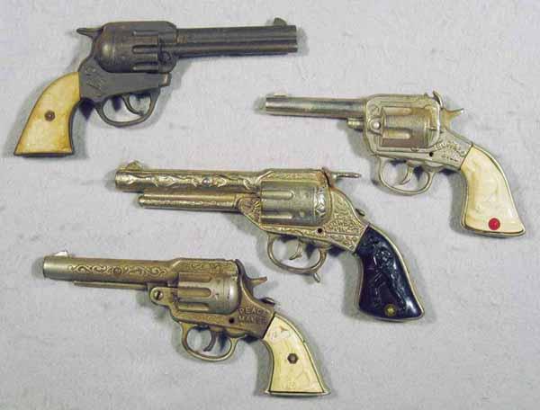 099: 4 TOY WESTERN REVOLVER CAP GUNS: all are cast iron w/plastic grips, Gene Autry, 8" long, Buffalo Bill, 7 1/2" long, Cowboy King, 9" long, Peacemaker, 8 1/2" long, C4-6.