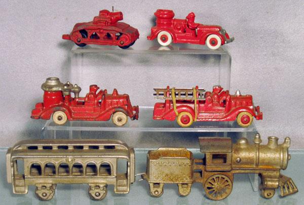 6 CAST IRON TOYS: Dent Train, nickelplated, 13" long, 2 Hubley Fire Trucks, both 5" long, the ladder truck is an old repaint, Arcade Pontiac Pumper, 5" long, restored, Arcade Tank, 4" long, old repaint, C4-6.