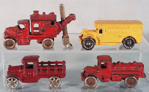 4 CAST IRON VEHICLES: Hubley Mack shovel truck, 4" long; AC Williams Moving & Storage Van, 3 3/4" long, old repaint; Kilgore express truck, 3 1/4" long, AC Williams gas tanker, 3 3/4" long, C4-6.