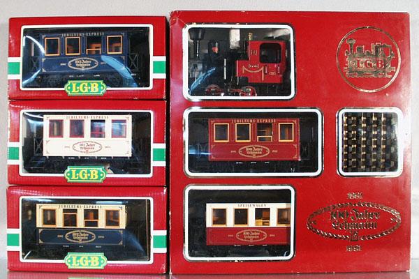 LGB 100th ANNIVERSARY TRAIN SET: G ga, loco & 2 coaches from 1981, w/coaches from 1982, 1983, 1984, all are unrun, orig boxes, C8-9.