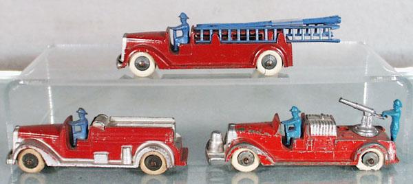 3 TOOTSIETOY MACK FIRE TRUCKS: 1040 ladder truck, 1042 insurance patrol, 1041 hose car, 2 tires worn, C4-5.