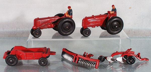 5 AUBURN RUBBER FARM VEHICLES: Graham Bradley tractor, 4" long, M&M tractor, 4 1/2" long, David Bradley spreader, disc harrow & plow, spreader has 2 broken tips off side stakes, C5-7.