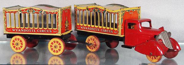 WYANDOTTE 503 CIRCUS TRUCK & TRAILER: pressed steel, wooden tires, 19" long, tow hook pin missing, truck cage roofs have faded, grille tarnished, missing tailgates, C6-7.