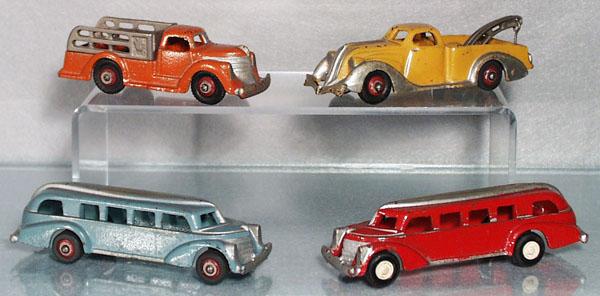 4 HUBLEY VEHICLES: painted cast iron, Stake Truck, 5" long, Wrecker, 5 1/2" long, 2 Buses, each 5 1/2" long, all have added paint highlights, the red bus has replaced wheels, C5.