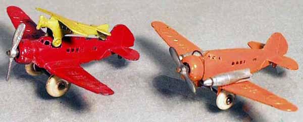 2 BARCLAY AIRPLANES: die cast, the red one has a yellow piggyback plane, the orange plane has silver bombs, both have 3 3/4" wingspan, C6-7.