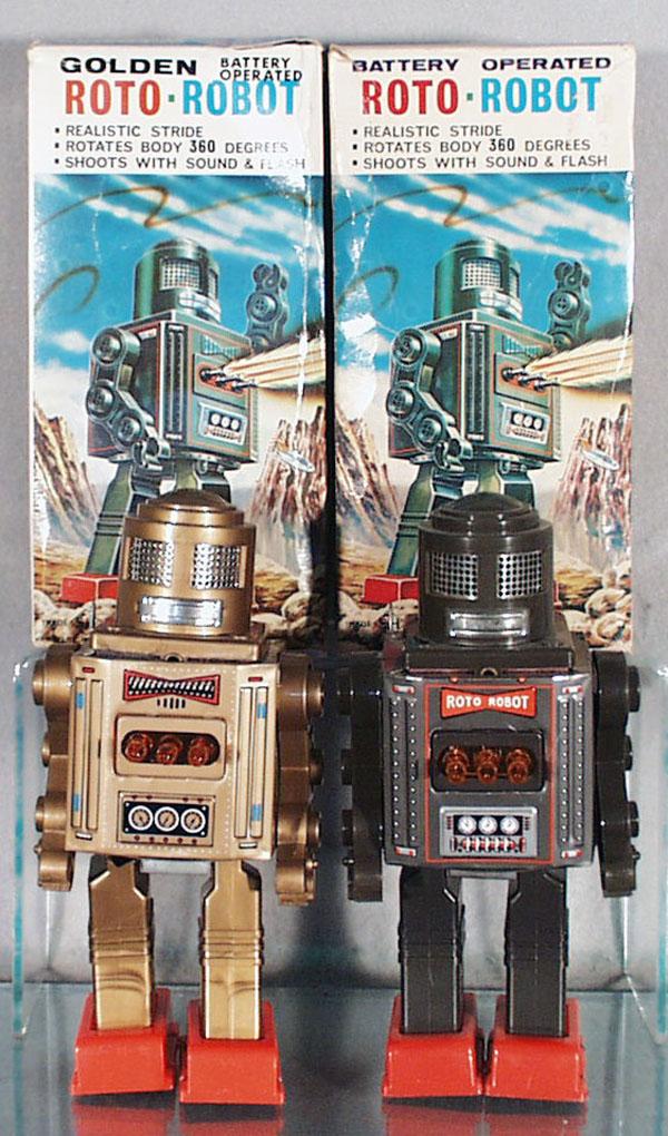 2 SH of JAPAN ROTO-ROBOTS: litho tin & plastic, 1 gold, 1 gray, battery operated, working, 9" tall, the gold one has a broken leg, orig boxes minor wear, C7-8.