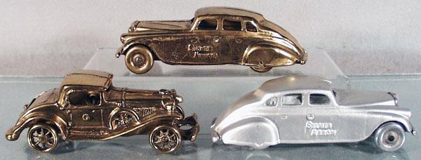 3 CAST IRON REPLICA AUTOS: 2 Arcade Silver Arrows, brass & aluminum, 7" long, Champion coupe, brass, 6 1/4" long, C6-7.