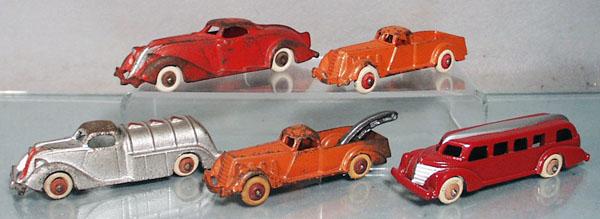 5 HUBLEY VEHICLES: painted cast iron, streamlined coupe, 6 1/4" long, pick up, 5" long, tank truck, 5 1/2" long, 1 tire flat, wrecker 5" long, bus, 5 3/4" long, 1 tire flat, restored, C4-8.