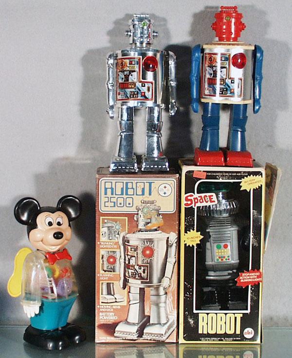 4 CONTEMPORARY ROBOTS: plastic, Mickey Mouse, windup working, 9" tall, Ahi unlicensed Lost in Space Robot B6 & 2 Robot 2500's, battery operated, not working, battery boxes clean, 10 1/4" & 10" tall, 2 orig boxes only, boxes