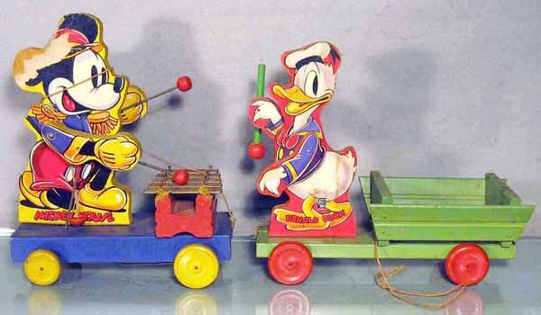 4 WOODEN PULL TOYS: 2 Disney Fisher Price Toys, black labels, 798 Mickey Mouse Drummer, paper tear on 1 side, 550-463 Donald Duck Cart, C6-8; 2 Brice Toy Buckin' Beauty Toys, 1 has small tears, all 4 are litho paper over