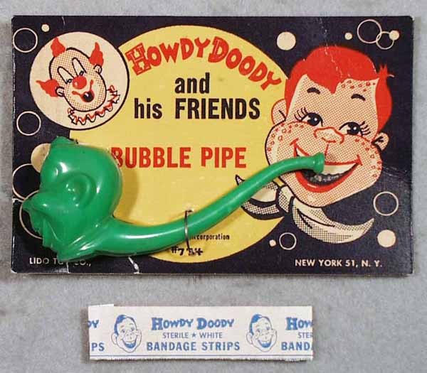 2 HOWDY DOODY ITEMS: Lido Toys Bubble Pipe, plastic, 4 1/2" long, orig card minor wear; Howdy Doody Bandage Strip, C5-7.