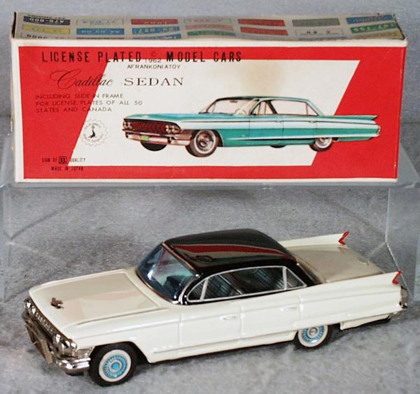 BANDAI 1962 CADILLAC SEDAN: litho tin, friction working, black & white, 8" long, w/orig license plate box, minor wear, C9.
