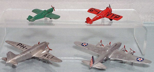 4 DINKY AIRPLANES: 60K Light Tourer, 60D Low Wing Monoplane, both have tin wings, 60T Douglas DC3, playworn, 60W Long Range Bomber, C4-6.