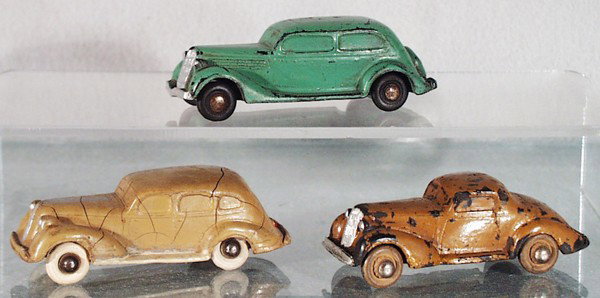 3 RUBBER AUTOS: 35 Ford, green, Perfect Rubber 35 Pontiac, brown, w/cracks, Rubba Toy 35 Olds, brown, w/chips, all grilles have touch up, C4-5.