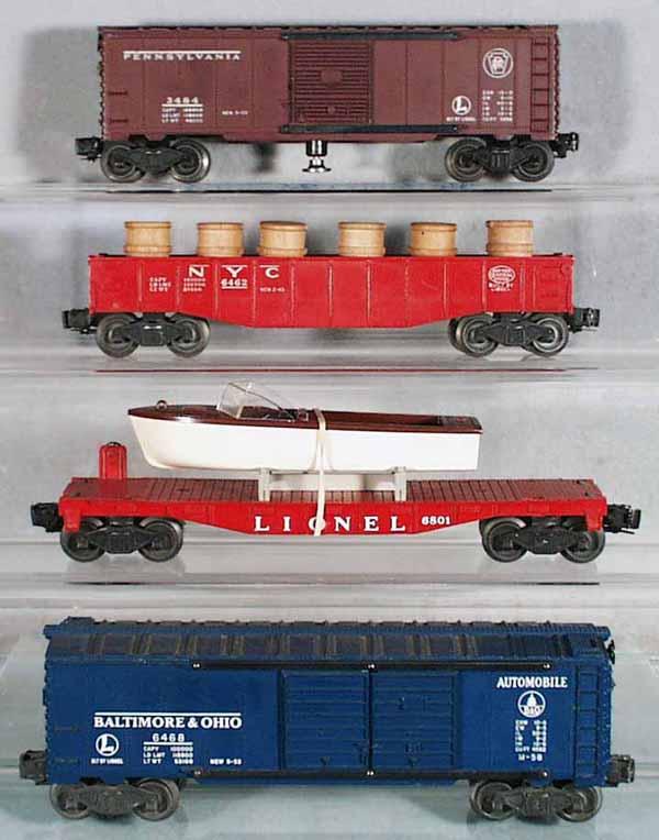 4 LIONEL FREIGHT CARS: O ga, 3484 operating PA box car, 4 steps chipped, 6462 gondola w/barrels, 6801 flat w/orig boat, 2 scratches on windshield, 6468 B&O auto box car, C5-7.