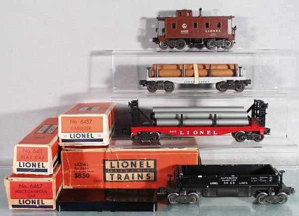 4 LIONEL FREIGHT CARS: O ga, 6457 caboose, missing 1 coupler, 6411 flat w/logs, 6467 miscellaneous car w/pipes, 3469 automatic dump w/bin, orig boxes worn, C5-6.
