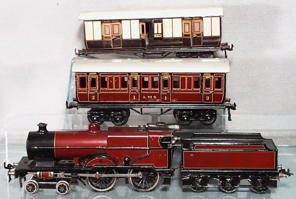 BING & BASSETT LOWKE TRAIN SET: O ga, Bassett Lowke 1190 loco, clockwork working, LMS tender, Bing LMS coach, Bing L&NWR coach, missing 1 truck, coaches are 9" long, C5-6.