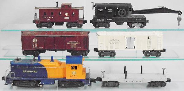 LIONEL TRAIN SET: O ga, 6250 Seaboard NW2 switcher, minor decal wear, 2411 flat car, 2458 automobile box car, 3462 milk car, 6460 crane, oxidation on trucks, 6457 caboose, C5-6.