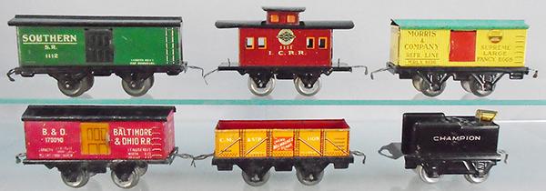 6 AMERICAN FLYER FREIGHT CARS: O ga, litho tin, 1112 SP box car, 1111 IC caboose, 1110 Morris Butter/Eggs, 1109 CMSTP sand car, Champion tender, C5-7.
