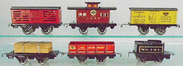 AMERICAN FLYER FREIGHT CARS: O ga, litho tin, 1119 stock car, 1111 cabose, 1110 Morris Bacon, 1141 lumber, 1109 LV sand car, 121 tender, C5-7.