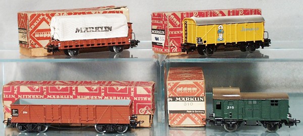 4 MARKLIN FREIGHT CARS: HO ga, 330 flat w/canvas cover, 322 banana van, 331 USA hopper, 310 box car, all are restored, orig boxes minor wear, C8-9.