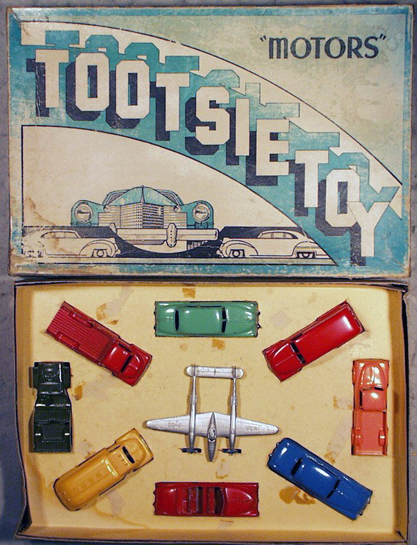TOOTSIETOY 7200 MOTORS SET: contains Ford Pick Up, Pontiac Coupe, Chevy Panel Truck, Jeep, P-38 Lightning, Chevy Pick Up, Ford Tanker, Olds Convertible, Mercury Sedan, orig box & insert minor wear, top worn, C6-8.