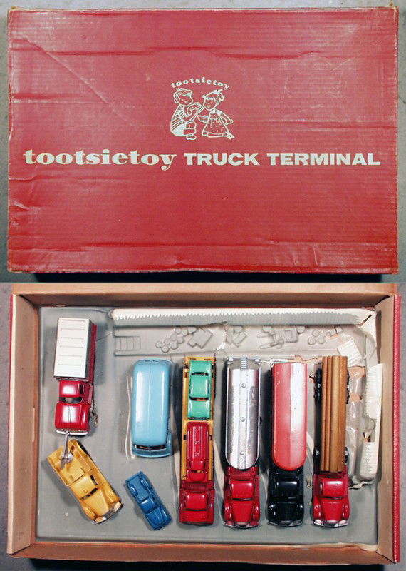 TOOTSIETOY 4600 TRUCK TERMINAL SET: contains Mack Log Truck, Mack Trailer, Mack Tanker, decals worn off, IH Auto Transport w/3 cars, IH Metro Van, MackWrecker, Ford Box Truck, w/plastic Terminal base, some cracks, orig box minor wear, C