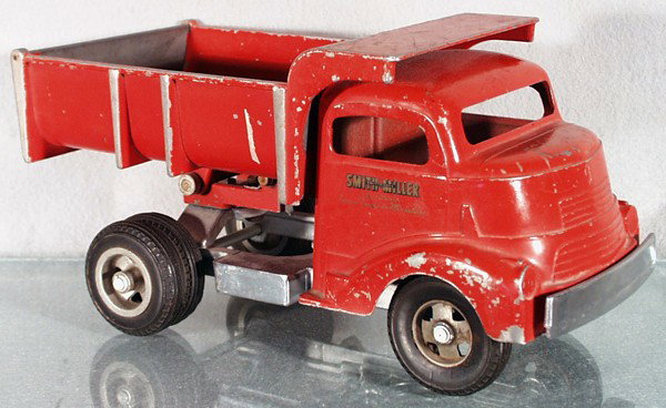 SMITH-MILLER DUMP TRUCK: painted cast iron, black rubber tires, paint worn, 11 1/2" long, C4-5.