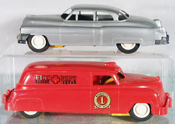 2 WYANDOTTE AUTOS: plastic, friction working slightly, 3100 Cadillac, 8 1/2" long, bumper paint worn, black rubber tires, 818 Fire Dept Rescue Squad Car, black rubber tires, 9" long, C5-6.
