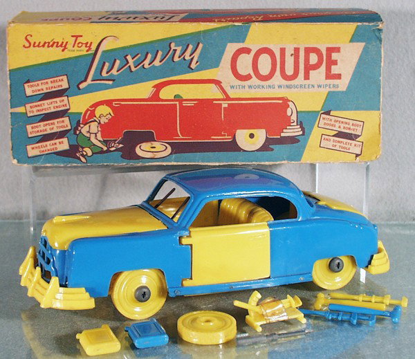 SUNNY TOY LUXURY COUPE: plastic, w/working windshield wipers, 10" long, missing axle nut to hold on 1 rear wheel, nib missing off hood to hold it in place, w/extra wheel, tools & 2 gas cans, orig box rough, C7.