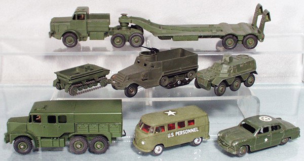 6 DINKY MILITARY VEHICLES: 660 Tank Transporter, 6898 Med Artillery Tractor, 822 Half Track, 162 Light Dragon Tractor, 676 Personnel Carrier, 675 Ford Staff Car, w/Corgi 356 VW Bus, C5-8.
