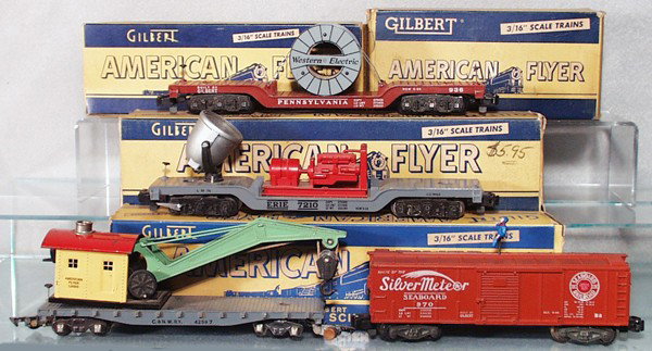 4 AMERICAN FLYER FREIGHT CARS: S ga, 936 cable reel flat car, 946 floodlight car, 907 boom car, bends on cab, 970 box car w/brakeman, orig boxes minor wear, C6-8.