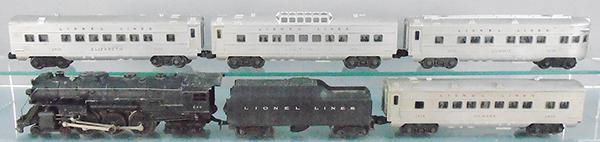LIONEL TRAIN SET: O ga, 646 loco w/smoke, missing boiler front jewels, 2046W tender, 2434 Newark Pullman, 2435 Elizabeth Pullman, 2432 Clifton vista dome, 2436 Summit obsv, cars are silver w/red letters & window silhou