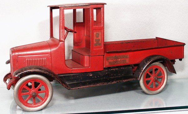 BUDDY L IHC RED BABY EXPRESS TRUCK: painted pressed steel, 24 1/2" long, painted around decals, fenders painted black, very old repaint, C5-6.