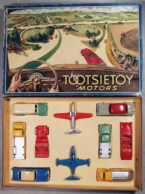 TOOTSIETOY 7200 MOTORS SET: contains Chevy Panel Van, P80 Shooting Star Jet, Pontiac Coupe, Ford Stake Truck, Jeep, Dodge Pick Up, Oldsmobile Convertible, Mercury Sedan, Panther Jet, Ford Tanker Truck, orig box & insert minor we