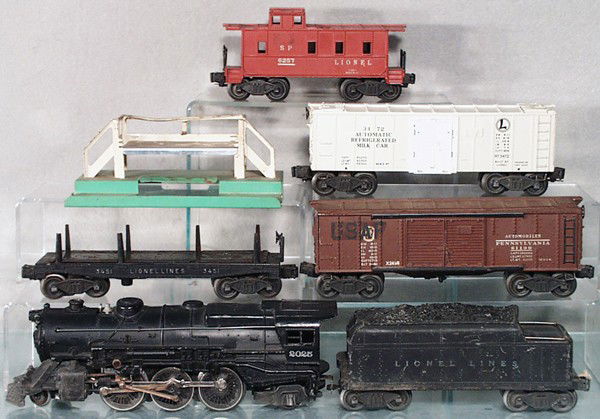 LIONEL TRAIN SET: O ga, 2025 loco, missing siderod eccentric on 1 side, 2466W tender, lettering worn, 3451 log dump, oxidation on platform, 2458 box car, 1 decal added, 3472 milk car w/platform, 6257 caboose, roof crac
