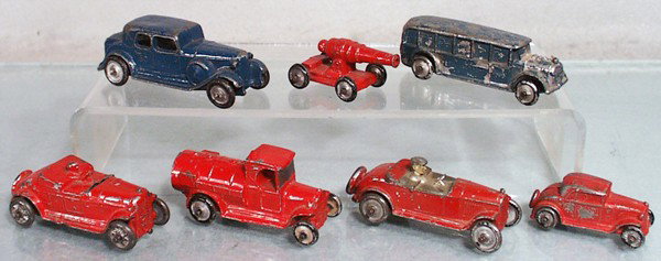 7 KANSAS TOY VEHICLES: slush die cast, 60 blue Sedan, 3 1/2" long, 34 red Cannon, 2 1/4" long, blue Fageol Bus, 3 1/2" long, red Roadster, 3 1/4" long, red Gas Tank Truck, 3" long, red Roadster, 3" long, windshield broken, 