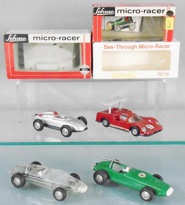 4 SCHUCO MICRO RACERS: 1037 Porsche, silver, orig box & insert, 1045 Chaparral, red, orig box minor wear, R276 1005 clear plastic Racer, missing exhaust pipe, issued through Creative Playthings, has body warp, orig box, 100