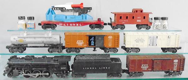 LIONEL TRAIN SET: O ga, 2026 loco, 6466WX tender, 6454 NYC box car, 3472 milk car, 3464 operating NYC box car, 6465 tank, 6650 missile firing car, 6257 caboose, w/4 bottles of smoke pellets, C6-8.