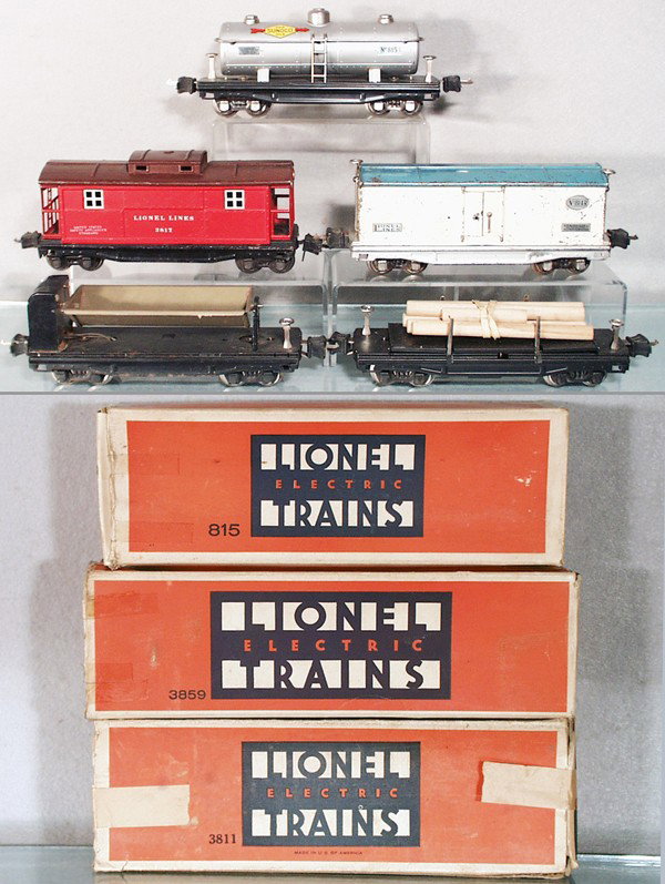 5 LIONEL FREIGHT CARS: O ga, 815 Sunoco tank, 2817 caboose, touch up on roof, 814R refrigerator car, missing catch on door, 3859 dump, bin & trucks repainted, 3811 lumber, trucks repainted, w/3 orig boxes only, boxes worn, 