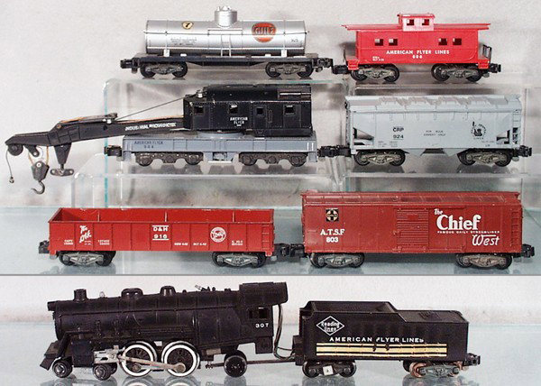 AMERICAN FLYER TRAIN SET: S ga, 307 loco & tender, 916 gondola, 803 box car, 944 crane, 924 cement car, 2 steps broken, 925 tank, 806 caboose, 4 pieces have old decals added, C5-6.