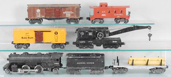 LIONEL TRAIN SET: O ga, 1654 loco, 1654W tender, surface oxidation spots, 2411 flat w/lumber, 2454 PRR box car, 2460 crane, 2458 automobile car, 6357 caboose, w/4 rough orig boxes, C5-6.