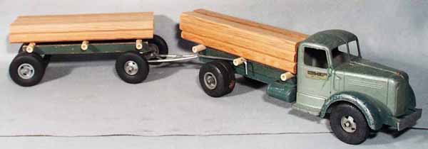 SMITH MILLER 404 MACK LUMBER TRUCK: die cast & wood, front bumper ends broken, headlights missing, 36" long, C4-5.